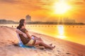 Couple watching romantic sunrise on the beach