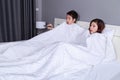 Couple watching scared movie with tv remote control under the bl