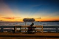 Couple watching sea sunset with twilight sky Royalty Free Stock Photo