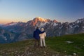 Couple watching sunrise over Mont Blanc summit Royalty Free Stock Photo