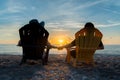 Couple Watching The Sunset On Beach