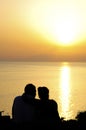 Couple watching the sunset in beach