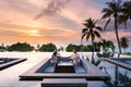 couple watching sunset in infinity pool on a luxury vacation in Thailand Royalty Free Stock Photo