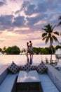 couple watching sunset in infinity pool on a luxury vacation in Thailand Royalty Free Stock Photo