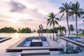 couple watching sunset in infinity pool on a luxury vacation in Thailand, man and woman watching sunset on the edge of a Royalty Free Stock Photo