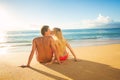 Couple Watching the Sunset on Tropical Beach Vacation Royalty Free Stock Photo