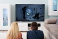 Couple Watching Suspense Movie On Television Royalty Free Stock Photo