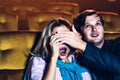 A couple watching a thriller movie in the cinema Royalty Free Stock Photo