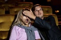 A couple watching a thriller movie in the cinema Royalty Free Stock Photo