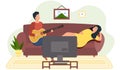 Couple watching tv and spend time together. Woman is listening to her boyfriend singing