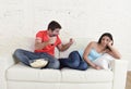 Couple watching tv sport football with man excited celebrating