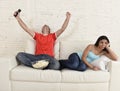 Couple watching tv sport football with man excited celebrating Royalty Free Stock Photo