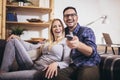 Couple is watching tv together and having fun in the living room Royalty Free Stock Photo