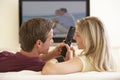 Couple Watching Widescreen TV At Home Royalty Free Stock Photo