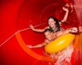 Couple in water slide at public swimming pool