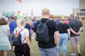 08/06/2019 Portsmouth Hampshire, UK A couple wearing backpacks walking through a crowd of people at a festival