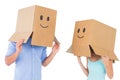 Couple wearing emoticon face boxes on their heads