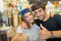 Couple wearing funny hats in costume shop