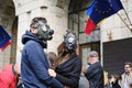 Couple wearing gas masks in protest for extreme air pollution, in front of the Ministry of Environment building Royalty Free Stock Photo