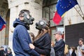 Couple wearing gas masks in protest for extreme air pollution, in front of the Ministry of Environment building. Royalty Free Stock Photo