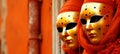 Couple wearing venetian carnival costumes posed in studio with copy space for text placement