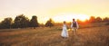 Couple in wedding attire against the backdrop of the field at sunset, the bride and groom. Royalty Free Stock Photo