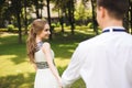 Couple in wedding attire is in the hands against the backdrop of the field at sunset, the bride and groom Royalty Free Stock Photo