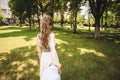 Couple in wedding attire is in the hands against the backdrop of the field at sunset, the bride and groom Royalty Free Stock Photo