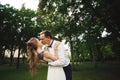 Couple in wedding attire is in the hands against the backdrop of the field at sunset, the bride and groom Royalty Free Stock Photo