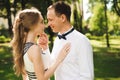 Couple in wedding attire is in the hands against the backdrop of the field at sunset, the bride and groom Royalty Free Stock Photo