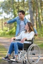 couple with wheelchair in autumn forest