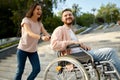 Couple with wheelchair goes up the stairs in park Royalty Free Stock Photo