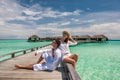Couple in white on a beach jetty at Maldives Royalty Free Stock Photo
