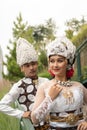 a couple in white clothes posing very intimately and intimately in a park