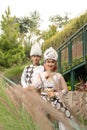 a couple in white clothes posing very intimately and intimately in a park