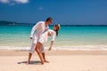 Couple in white having fun on a beach