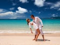 Couple in white having fun on a beach