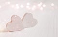 Couple of white wooden hearts. Glitter overlay