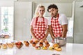 Couple of wife and husband cooking pastries at the kitchen skeptic and nervous, frowning upset because of problem Royalty Free Stock Photo