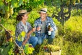 Couple of winegrowers tasting white wine in vineyard Royalty Free Stock Photo