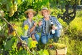 Couple of winegrowers tasting white wine in vineyard Royalty Free Stock Photo