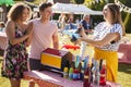 Couple Winning Prize At Tombola Stall At Busy Summer Garden Fete