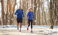 Couple in winter running together in nature Royalty Free Stock Photo