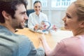 Couple wishing to have children in fertility clinic with doctor Royalty Free Stock Photo