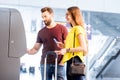 Couple withdrawing money at the airport