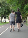 Couple, Woman Dominant Partner, Walking In A Park