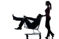 Couple woman with man sitting in shopping cart silhouette Royalty Free Stock Photo