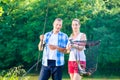 Couple sport fishing bragging with fish caught Royalty Free Stock Photo