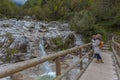 Couple of women shooting beautiful waterfalls with the phone Royalty Free Stock Photo