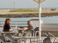 Couple of women sitting having a drink on a terrace overlooking the sea in Lanzarote, Canary Islands